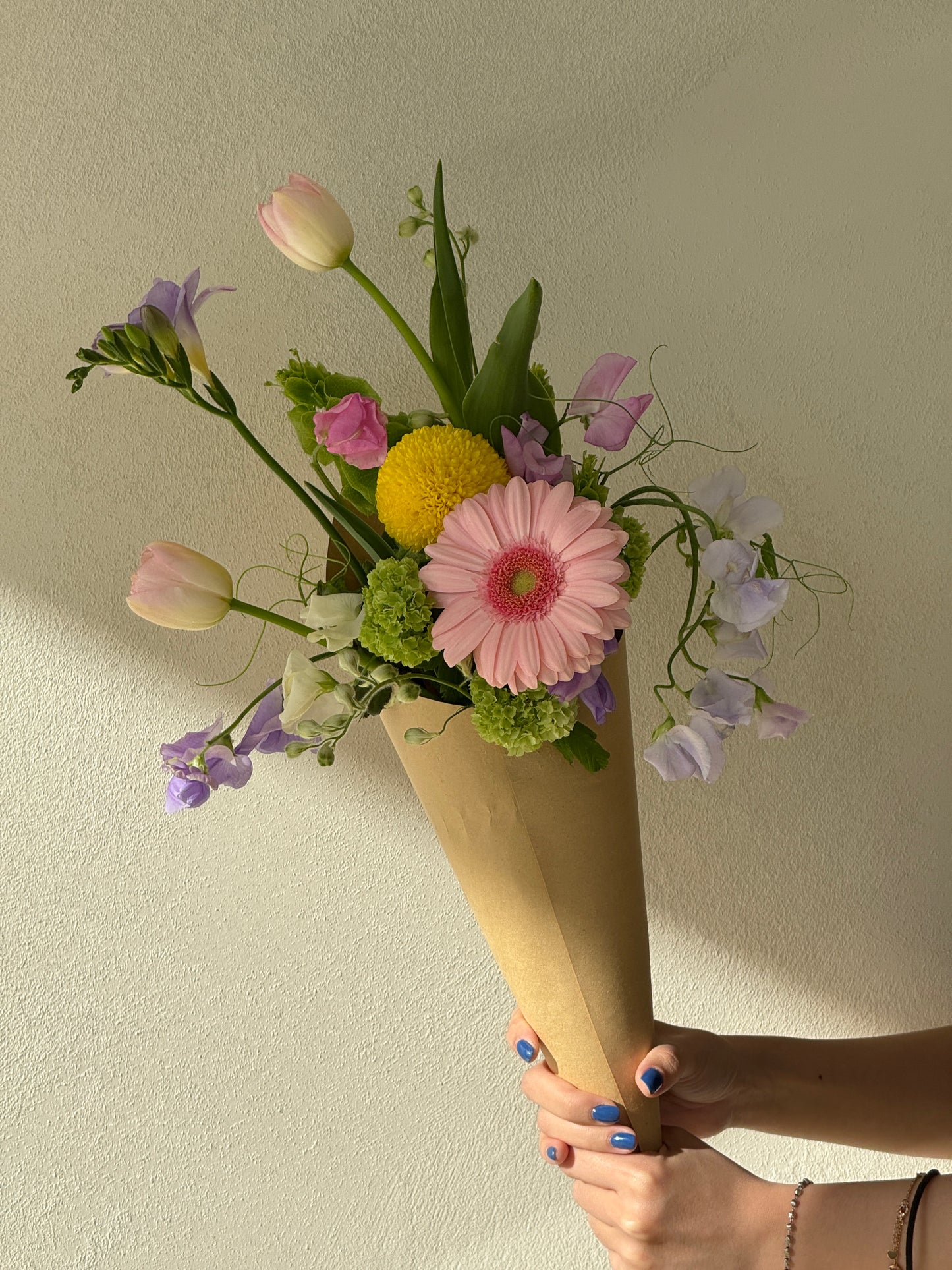 Custom ice cream bouquet with pastel seasonal flowers wrapped in a cone, handcrafted by Rōhi Lab in Auckland