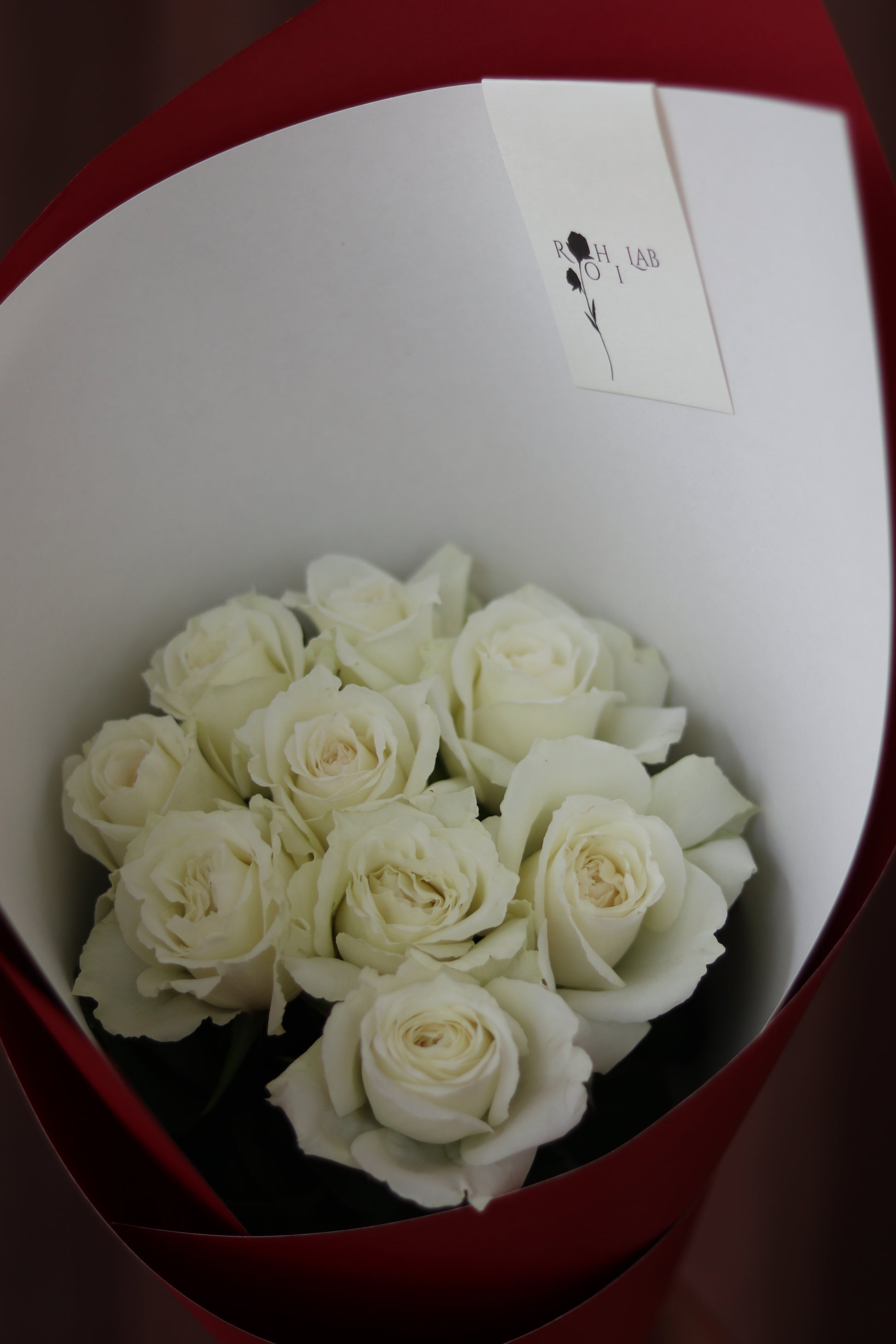 Close-up of fresh white roses in rounded bouquet, highlighting soft petals and elegant craftsmanship