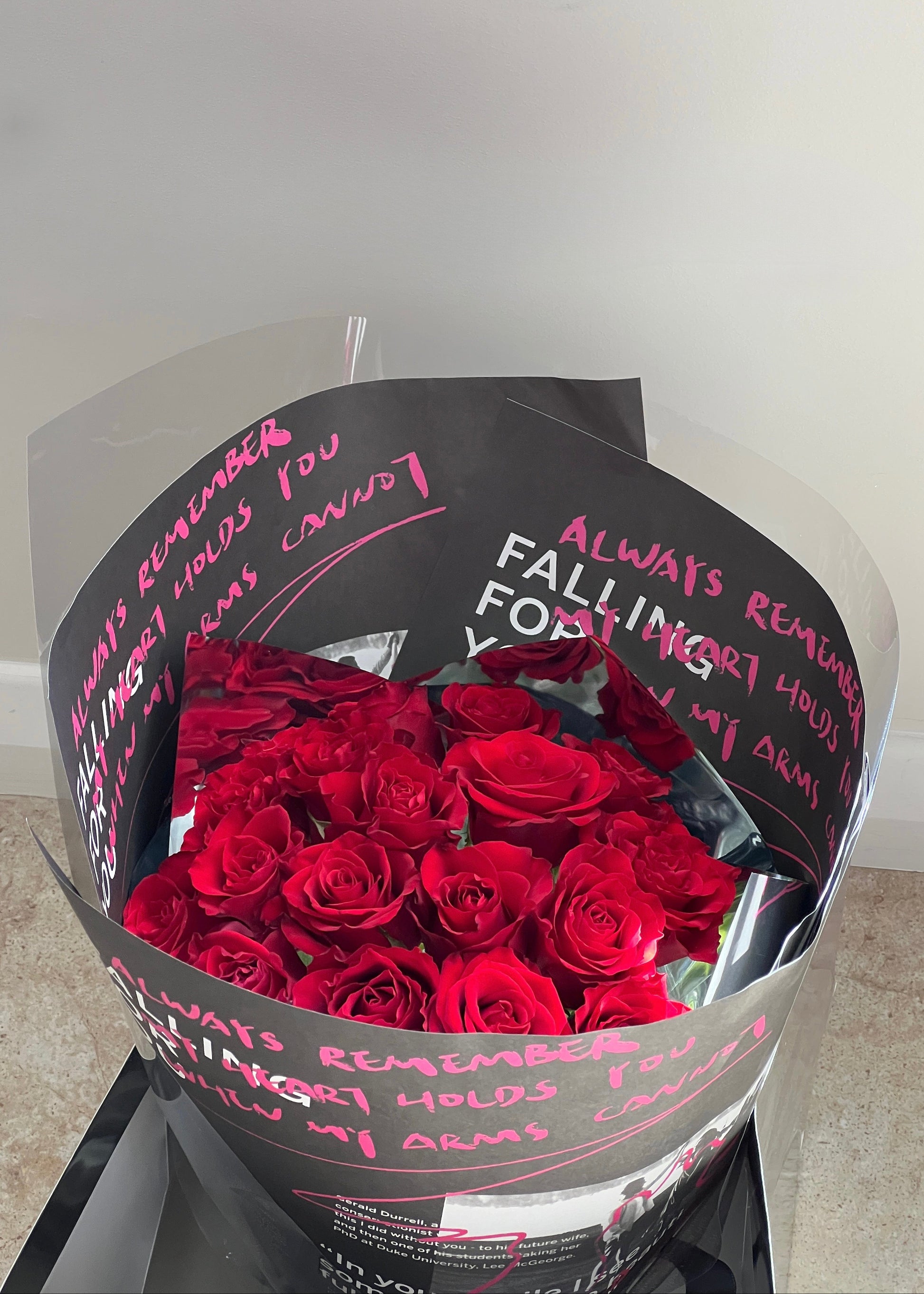 Red roses round bouquet with artistic wrapping paper, luxury romantic flower arrangement