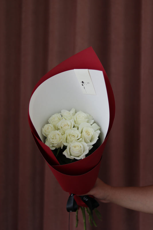 Pure Love white rose bouquet wrapped in signature red paper, hand-tied floral gift by Rōhi Lab Auckland