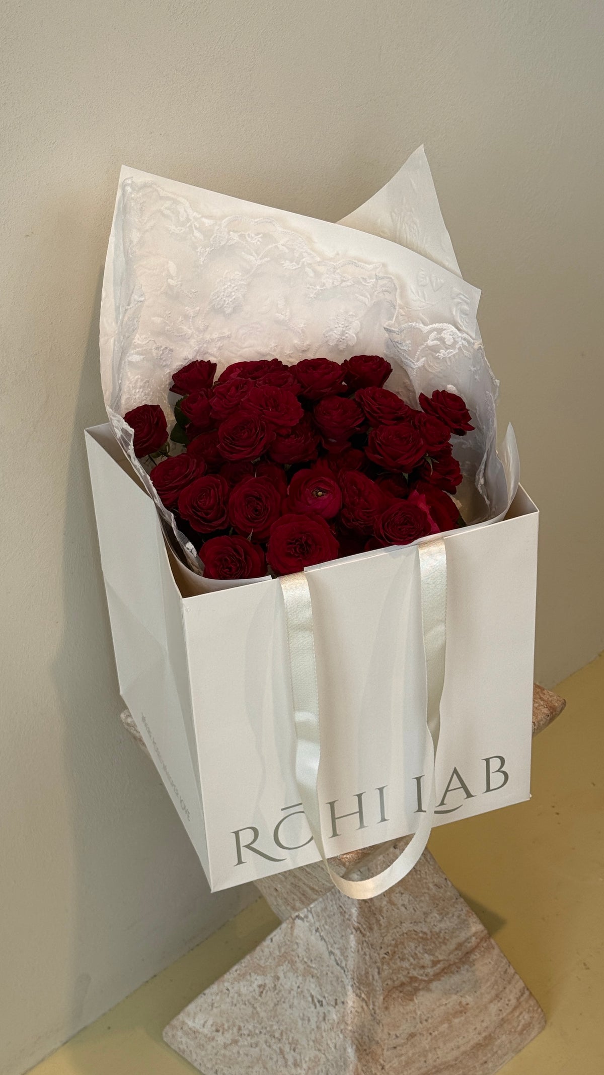 Romantic red spray roses presented in elegant white floral wrapping