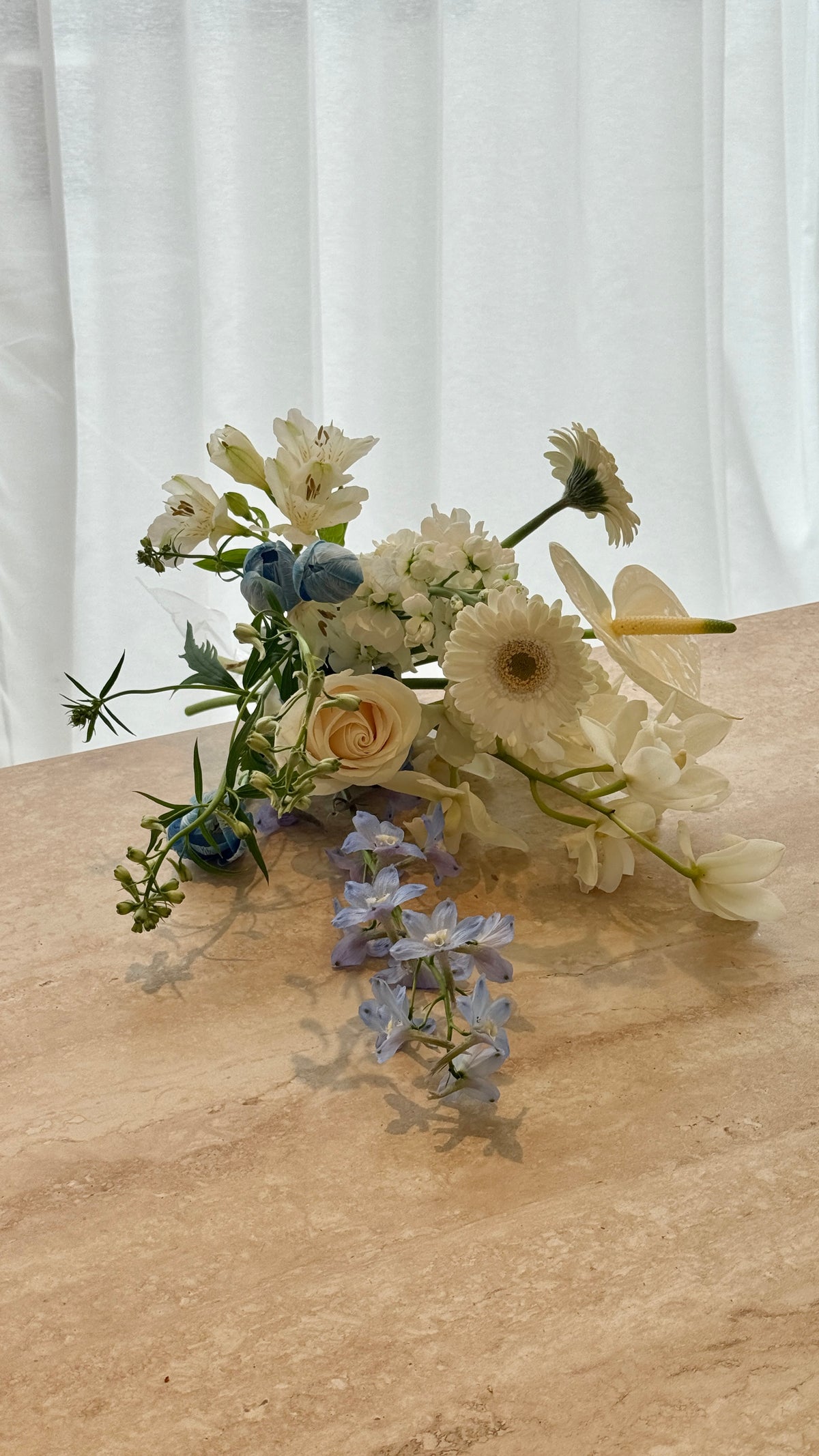 Fresh blue and white seasonal flower bouquet in neutral wrapping, handcrafted in Auckland