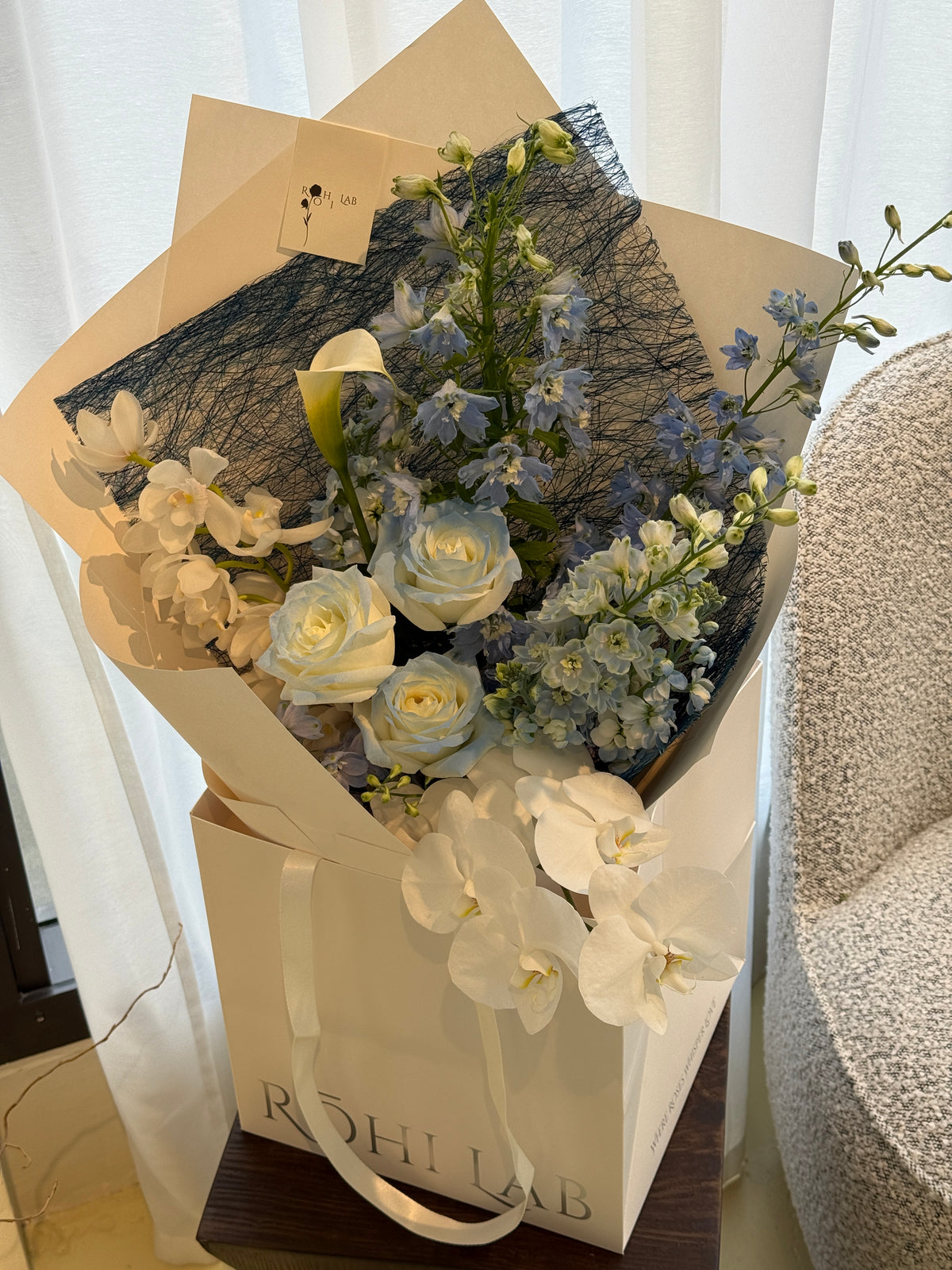 Daydream Blue and White Flower Bouquet with seasonal blooms in natural paper wrapping